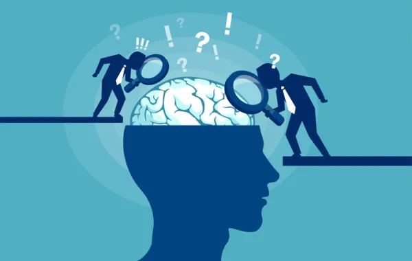 Foto con un visual de una cabeza que se ve un cerebro observado con lupas por dos figuras