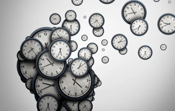 Foto de perfil de una cabeza con imágenes de esferas de reloj que van volando hacia arriba