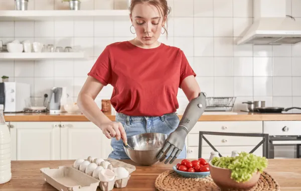 Foto de una chica joven cocinando y con un brazo para discapacidades