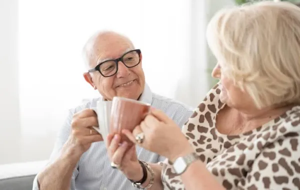 Pareja mayor brindando en un piso tutelado