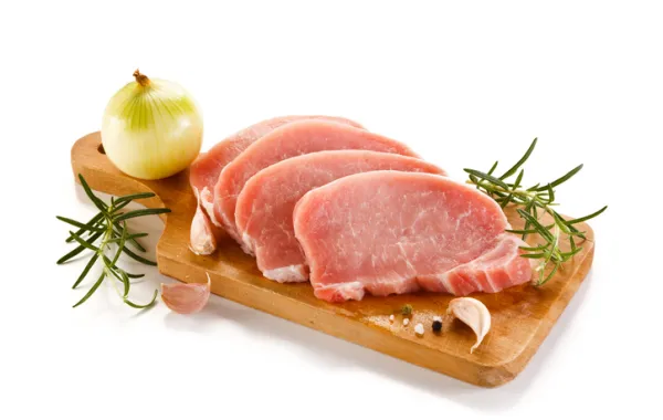 Foto de unos filetes de carne magra de cerdo en una bandeja decorada con vegetales