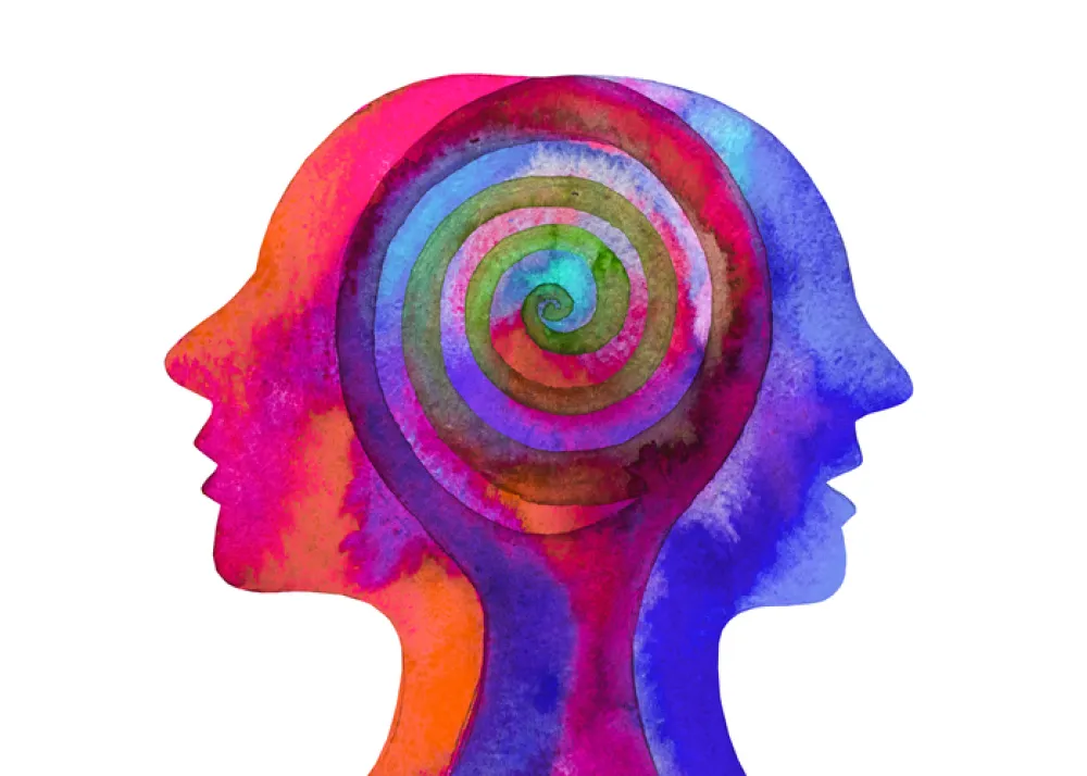 Foto con un dibujo de colores que representa de dos cabezas juntas mirando a lados opuestos